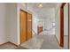 Bright hallway with tile flooring at entry, and neutral carpet leading to a staircase at 9693 W Euclid Dr, Littleton, CO 80123