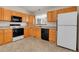 Functional kitchen featuring bright cabinets, modern appliances, and a window for natural light at 9693 W Euclid Dr, Littleton, CO 80123