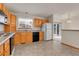 Functional kitchen featuring bright cabinets and modern appliances with an open design at 9693 W Euclid Dr, Littleton, CO 80123