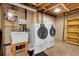 Basement laundry room featuring washer, dryer, and utility sink at 9693 W Euclid Dr, Littleton, CO 80123