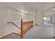 Bright living room featuring a wooden railing staircase and an open floor plan with lots of natural light at 9693 W Euclid Dr, Littleton, CO 80123