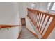 Carpeted stairs with wooden banister, and wooden trim at 9693 W Euclid Dr, Littleton, CO 80123