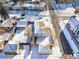 An aerial view of the property showcasing the duplex with fenced yard and surrounding neighborhood in winter at 2293 S Sherman St, Denver, CO 80210