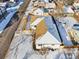 A bird's eye view of a snow-covered house featuring a large, fenced yard and a detached garage at 2293 S Sherman St, Denver, CO 80210