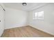 Bright and minimalist bedroom with a large window, hardwood floors, and a closet with sliding doors at 2293 S Sherman St, Denver, CO 80210