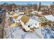 Aerial view of a house with snow-covered roof, fenced yard and mountain views in the distance at 2293 S Sherman St, Denver, CO 80210