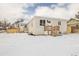 Charming duplex with white brick, snowy yard, and inviting wood stairs to the front doors at 2293 S Sherman St, Denver, CO 80210