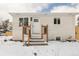 Inviting white brick home with a well-kept yard and wooden porch steps at 2293 S Sherman St, Denver, CO 80210