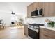 Open kitchen with stainless steel appliances, modern cabinets, and view to the living room at 2293 S Sherman St, Denver, CO 80210