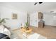 Bright living room with laminate floors, neutral paint and view into the kitchen at 2293 S Sherman St, Denver, CO 80210