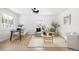 Bright living room features wood floors, neutral decor, a ceiling fan and large windows at 2293 S Sherman St, Denver, CO 80210