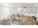 A cozy living room next to a bright kitchen featuring modern appliances and ample counter space at 2293 S Sherman St, Denver, CO 80210