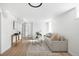 Inviting living room with comfortable seating, a stylish coffee table, and bright sunlight through a large window at 2293 S Sherman St, Denver, CO 80210