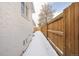 Side yard featuring a crisp white brick wall with a newly built wooden privacy fence at 2293 S Sherman St, Denver, CO 80210