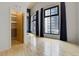 Bedroom with dark accent wall, closet, and ample natural light at 3100 Huron St # 4N, Denver, CO 80202