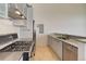 Stylish kitchen boasts stainless steel appliances, modern cabinetry, and ample counter space at 3100 Huron St # 4N, Denver, CO 80202