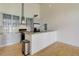 Modern kitchen featuring stainless steel appliances, light wood floors, and ample cabinet space at 3100 Huron St # 4N, Denver, CO 80202