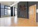 Bright living room with hardwood floors, industrial ductwork, and large windows offers modern, stylish living at 3100 Huron St # 4N, Denver, CO 80202