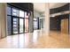 Spacious living room features large windows, balcony, and hardwood floors, offering modern urban living at 3100 Huron St # 4N, Denver, CO 80202
