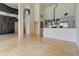 Expansive open living area with modern kitchen, hardwood floors, and industrial design elements at 3100 Huron St # 4N, Denver, CO 80202