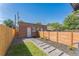Fenced backyard featuring a brick building with a door and windows, and a walkway at 3329 N High St, Denver, CO 80205