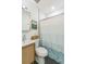 Bathroom featuring hexagon tile floor, toilet, shower with a striped curtain, and a vanity at 3329 N High St, Denver, CO 80205