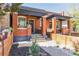 Charming brick duplex with a covered porch, landscaping, and a welcoming entrance at 3329 N High St, Denver, CO 80205