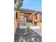 Charming brick home with a covered porch and a beautifully landscaped yard at 3329 N High St, Denver, CO 80205