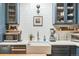 Well-appointed kitchen with white countertops, farmhouse sink, and blue cabinetry at 3329 N High St, Denver, CO 80205