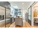 Open-concept kitchen with stainless steel appliances, white subway tile, and an island that provides extra counter space at 3329 N High St, Denver, CO 80205
