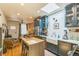 Cozy kitchen featuring stainless steel appliances, island, and open floor plan at 3329 N High St, Denver, CO 80205
