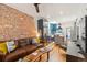 Cozy open-concept living space flowing into the kitchen, featuring exposed brick at 3329 N High St, Denver, CO 80205