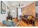 Bright living room with exposed brick, hardwood floors, and stylish decor at 3329 N High St, Denver, CO 80205