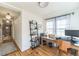 Spacious home office with hardwood floors, computer, and shelving with books at 3329 N High St, Denver, CO 80205