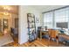 Bright home office space featuring hard wood flooring, and desk and a decorative book case at 3329 N High St, Denver, CO 80205