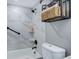 Bright bathroom features decorative tile, shower head, tub and toiletry storage at 4899 S Dudley St # 5H, Littleton, CO 80123