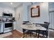 Eat-in dining area featuring a granite top table, designer mirror, and hardwood flooring at 4899 S Dudley St # 5H, Littleton, CO 80123