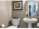 Small bathroom with pedestal sink and toilet at 6515 S Killarney Ct, Aurora, CO 80016