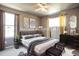 Bedroom with a double bed, dark dresser, and neutral decor at 6515 S Killarney Ct, Aurora, CO 80016