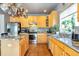 Kitchen with granite countertops, stainless steel appliances, and wood cabinets at 6515 S Killarney Ct, Aurora, CO 80016