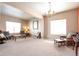 A cozy living room with neutral walls and carpet, offering comfortable seating and natural light through bright windows at 6515 S Killarney Ct, Aurora, CO 80016