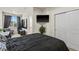 Comfortable bedroom with mounted TV, closet, and natural light at 4100 Albion St # 424, Denver, CO 80216