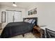 Bedroom with stylish black bed frame, barn door, and nature-themed wall decor at 4100 Albion St # 424, Denver, CO 80216