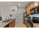 Modern kitchen with stainless steel appliances and breakfast bar at 4100 Albion St # 424, Denver, CO 80216