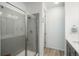 Clean bathroom with a walk-in shower and gray tile at 27728 E 10Th Dr, Aurora, CO 80018