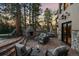 Outdoor patio with a stone fireplace, seating, and sunset views at 5085 Knobcone Dr, Castle Rock, CO 80108