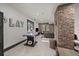 Finished basement with a recreation area, brick accent wall, and ample space for entertainment at 5085 Knobcone Dr, Castle Rock, CO 80108