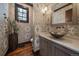 Stylish powder room features patterned wallpaper, hardwood floors, and a vessel sink at 5085 Knobcone Dr, Castle Rock, CO 80108