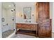 Modern bathroom showcasing a glass-enclosed shower, marble countertops, and custom wood vanity at 5085 Knobcone Dr, Castle Rock, CO 80108