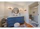 Charming bathroom with a blue vanity and tiled walk-in shower at 5085 Knobcone Dr, Castle Rock, CO 80108
